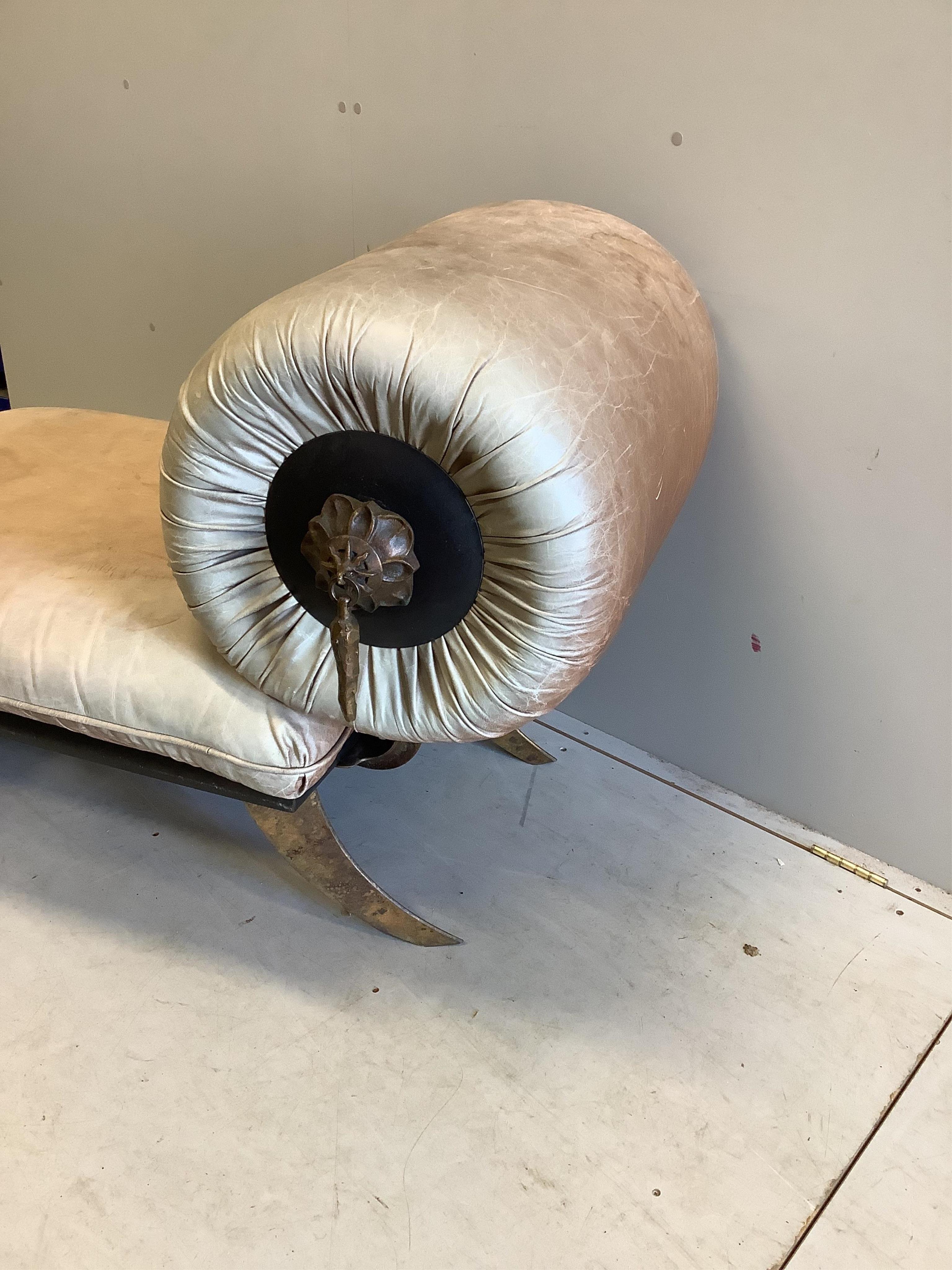 A Contemporary leather upholstered small chaise with animal hoof feet, width 128cm, depth 72cm, height 80cm. Condition - fair